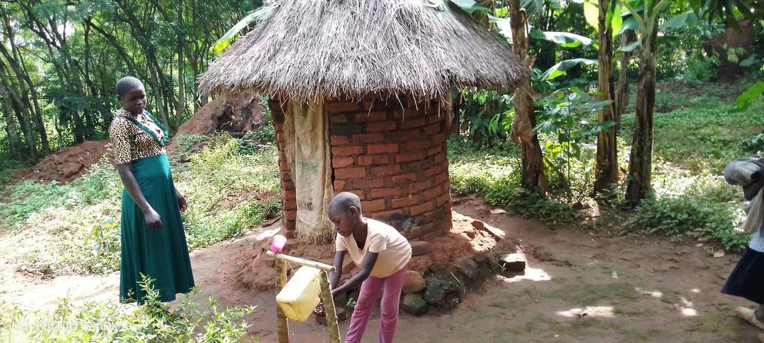 A girl washing her hands at a handwashing station